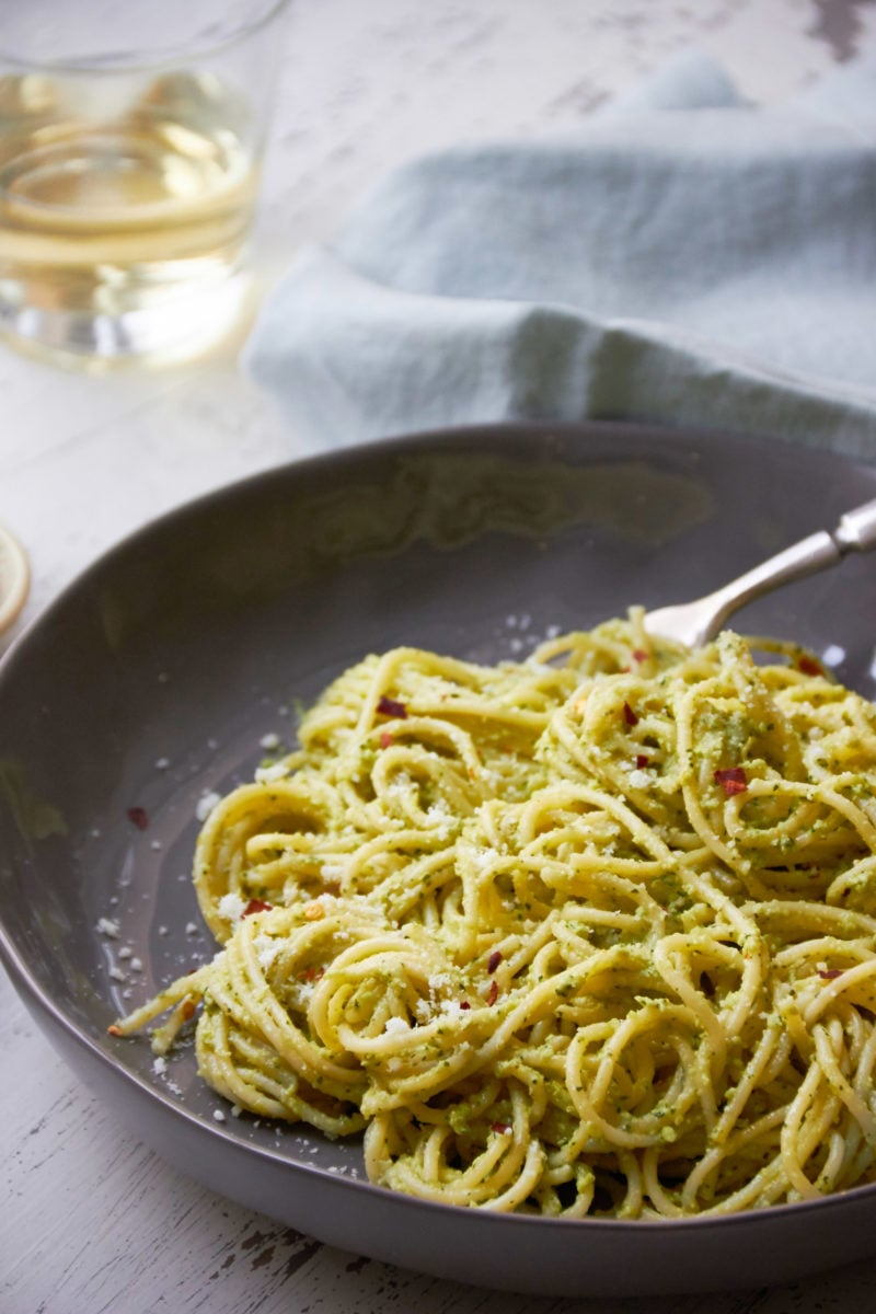 Pasta with Edamame, Mint and Basil Pesto on a grey plate.