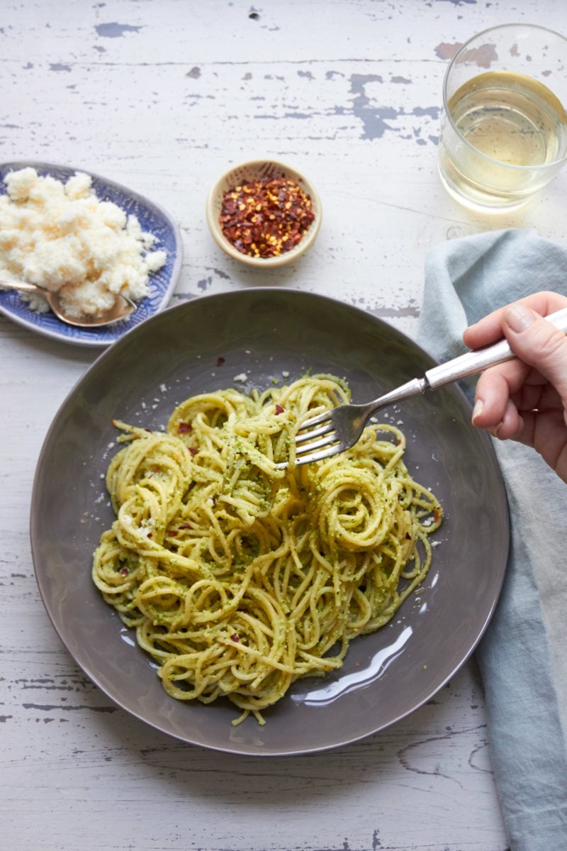 Person using a fork to grab some Pasta with Edamame, Mint and Basil Pesto.