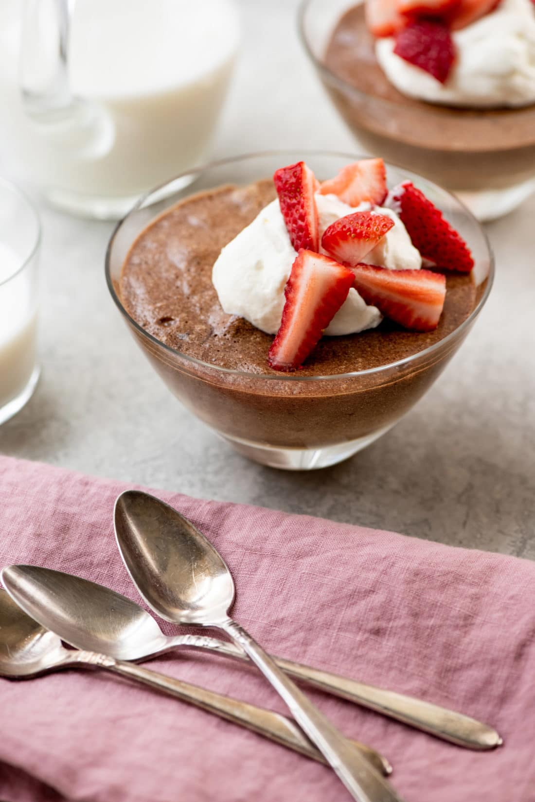 Chocolate Mousse topped with whipped cream and strawberries.