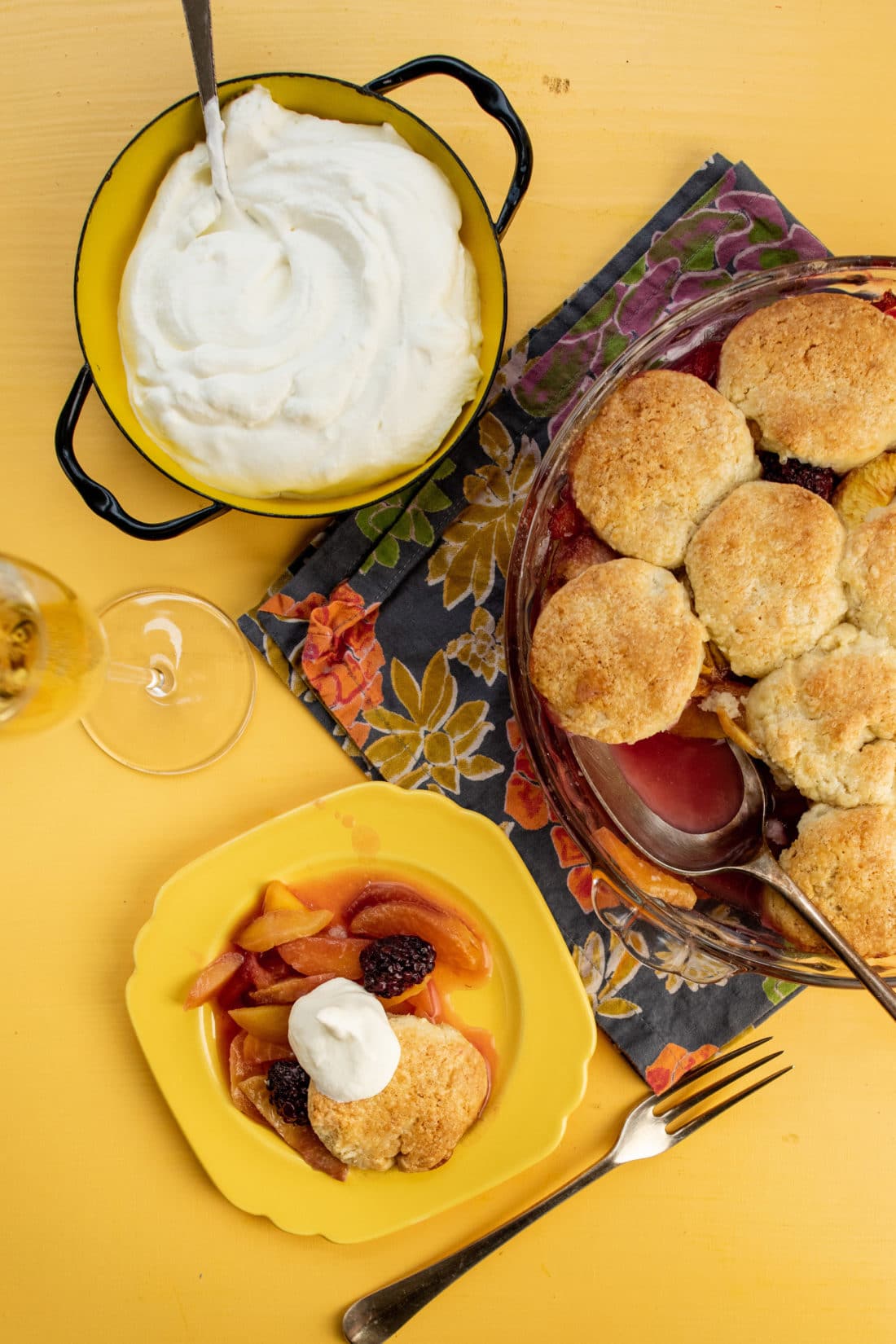 Sour Cream Biscuit Peach and Berry Cobbler in a dish and on a plate.