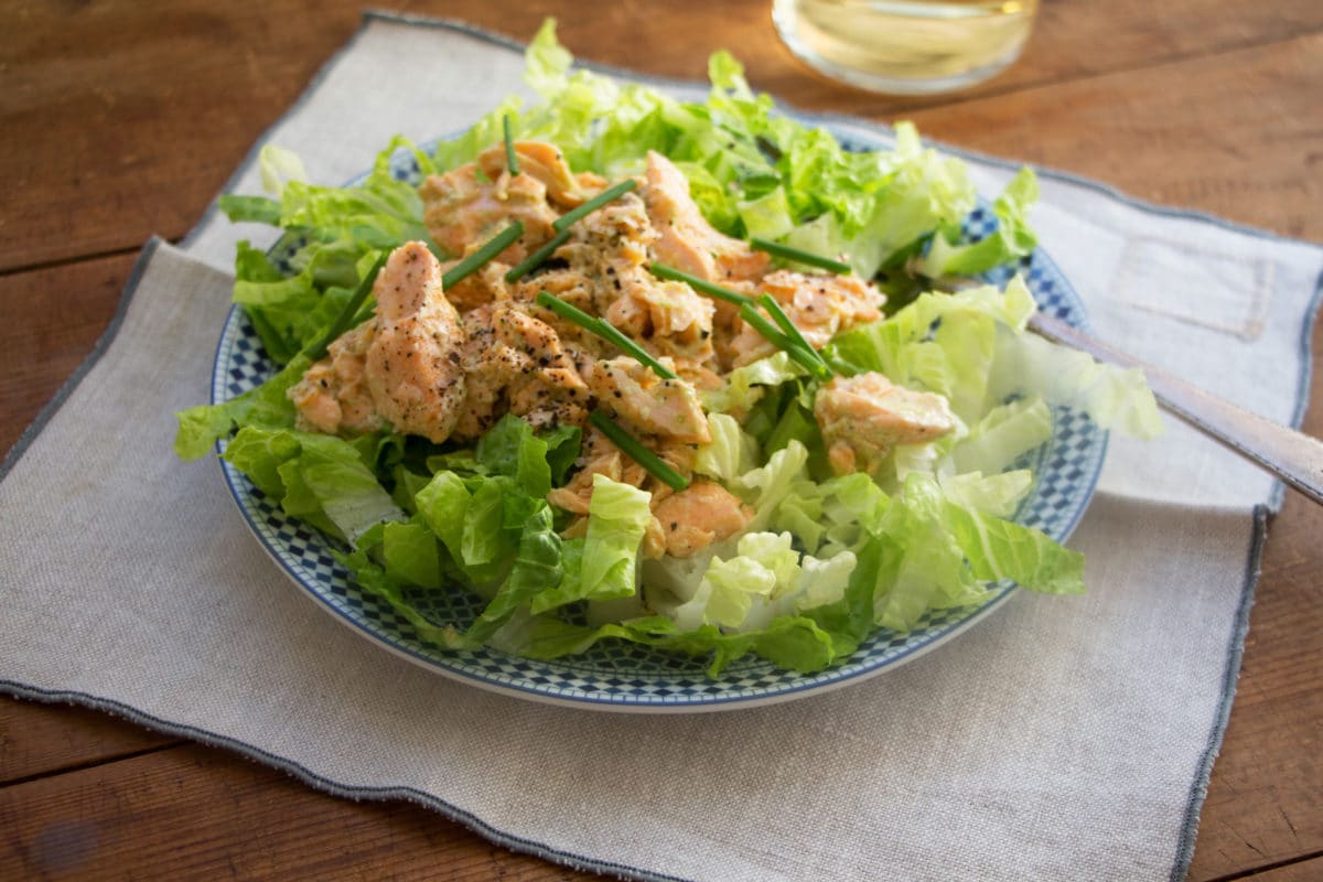 Salmon Salad with Jalapeno Scallion Dressing on a blue and white plate.