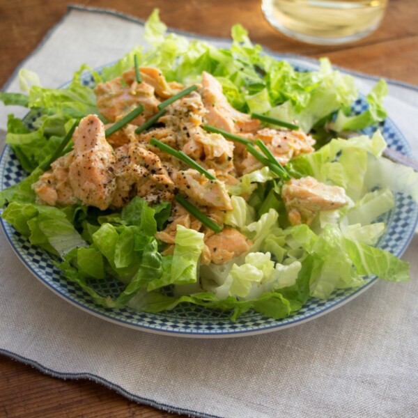 Salmon Salad with Jalapeno Scallion Dressing on a blue and white plate.
