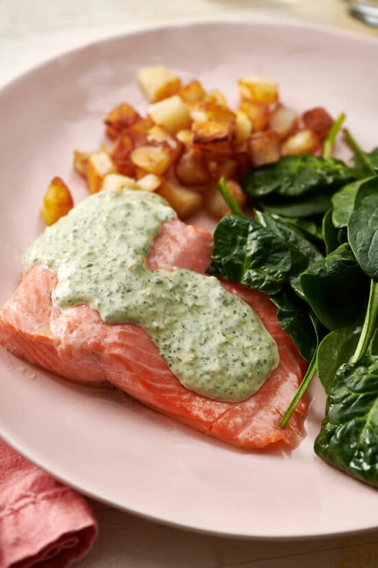 Poached Salmon topped with Cilantro Sauce on a plate.