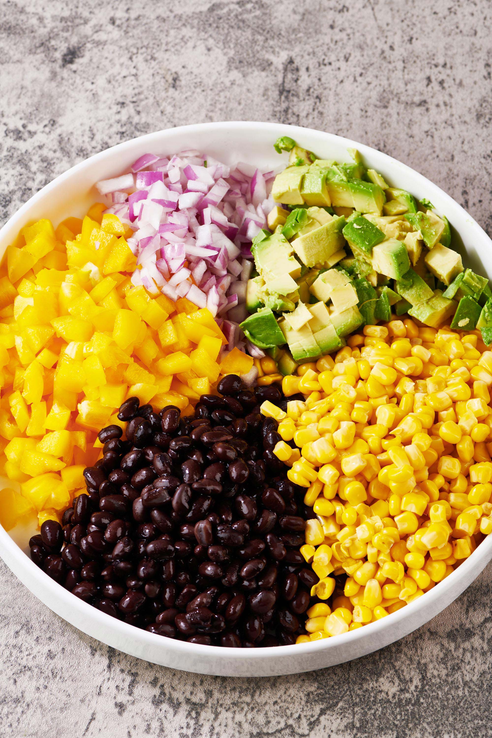 Ingredients for Cowboy Caviar, including corn and black beans, in a bowl.