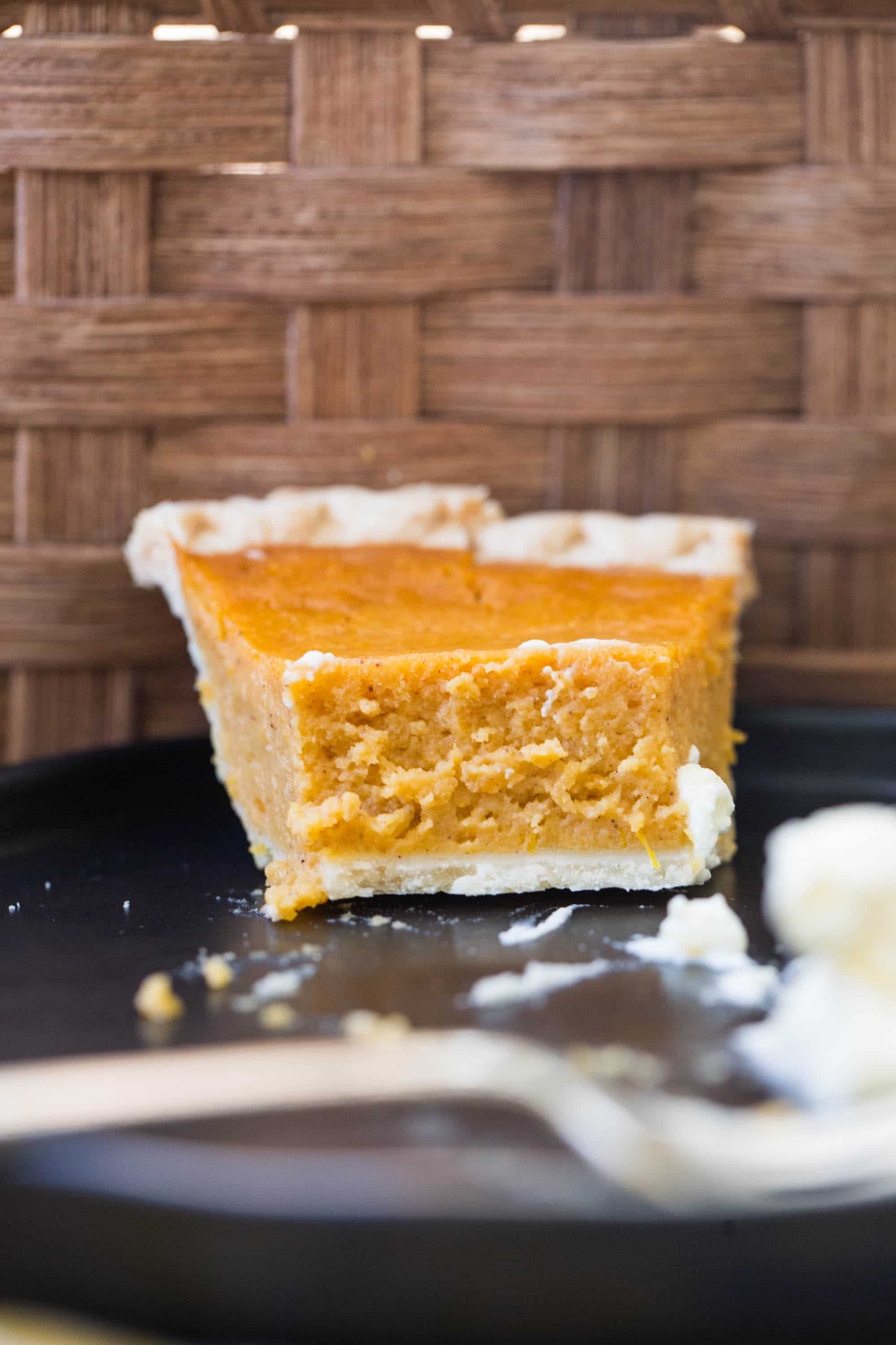 Sweet Potato Pie on a plate with a spoonful taken out.