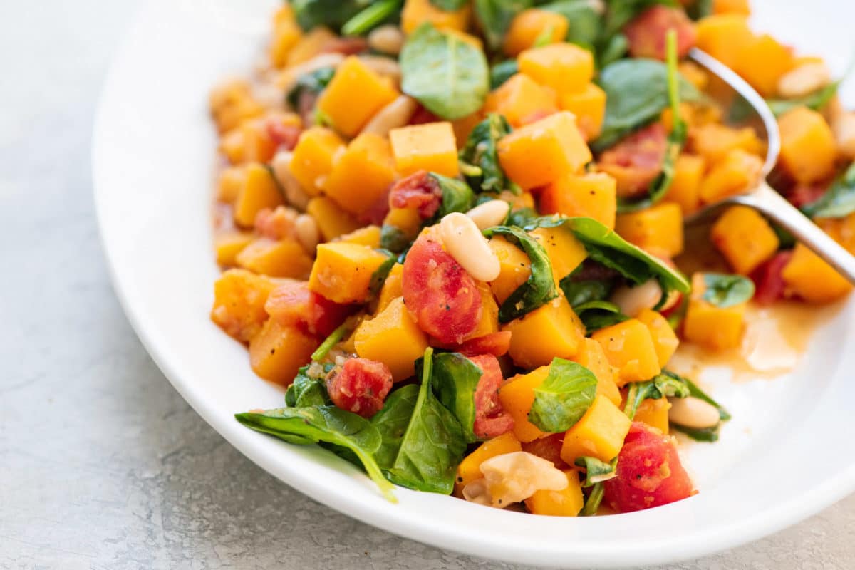 Butternut Squash and White Bean Ragout piled on a white dish.