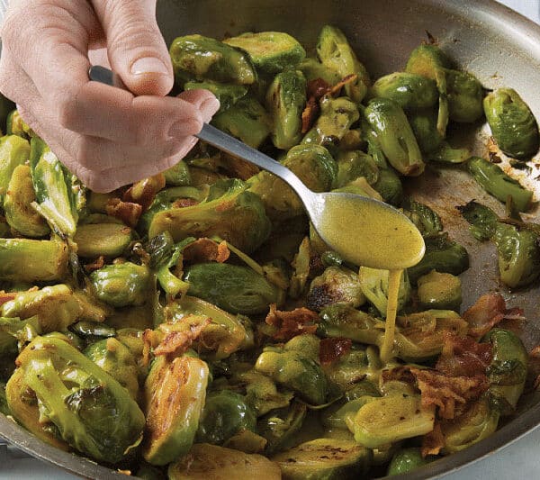 Pan of Brussels sprouts and drizzle of Bacon-Mustard vinaigrette.