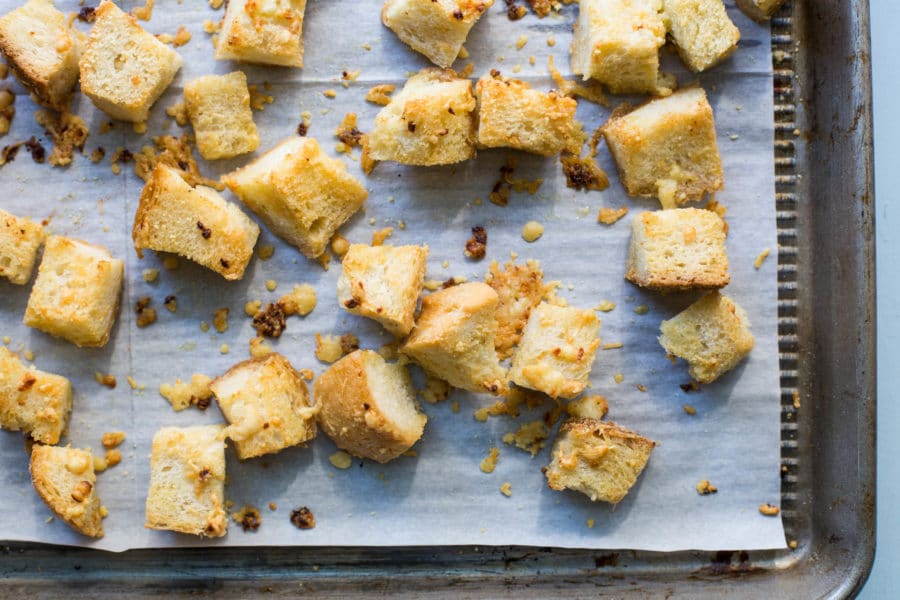 Lined baking sheet of Parmesan Croutons.