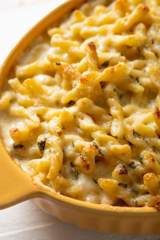 Yellow, oblong baking dish of Creamy Four-Cheese Pasta.