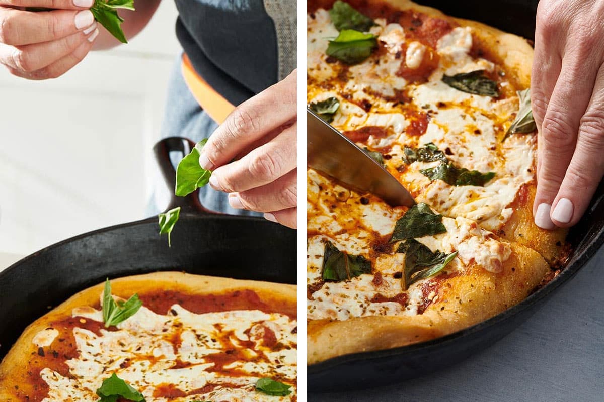 Adding fresh basil and slicing homemade pizza in cast iron pan.