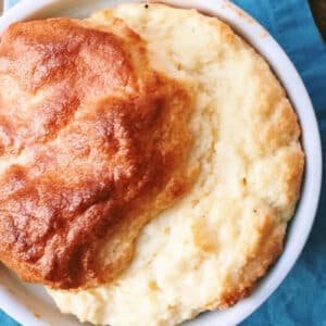 Cheese souffle in bowl on blue napkin.