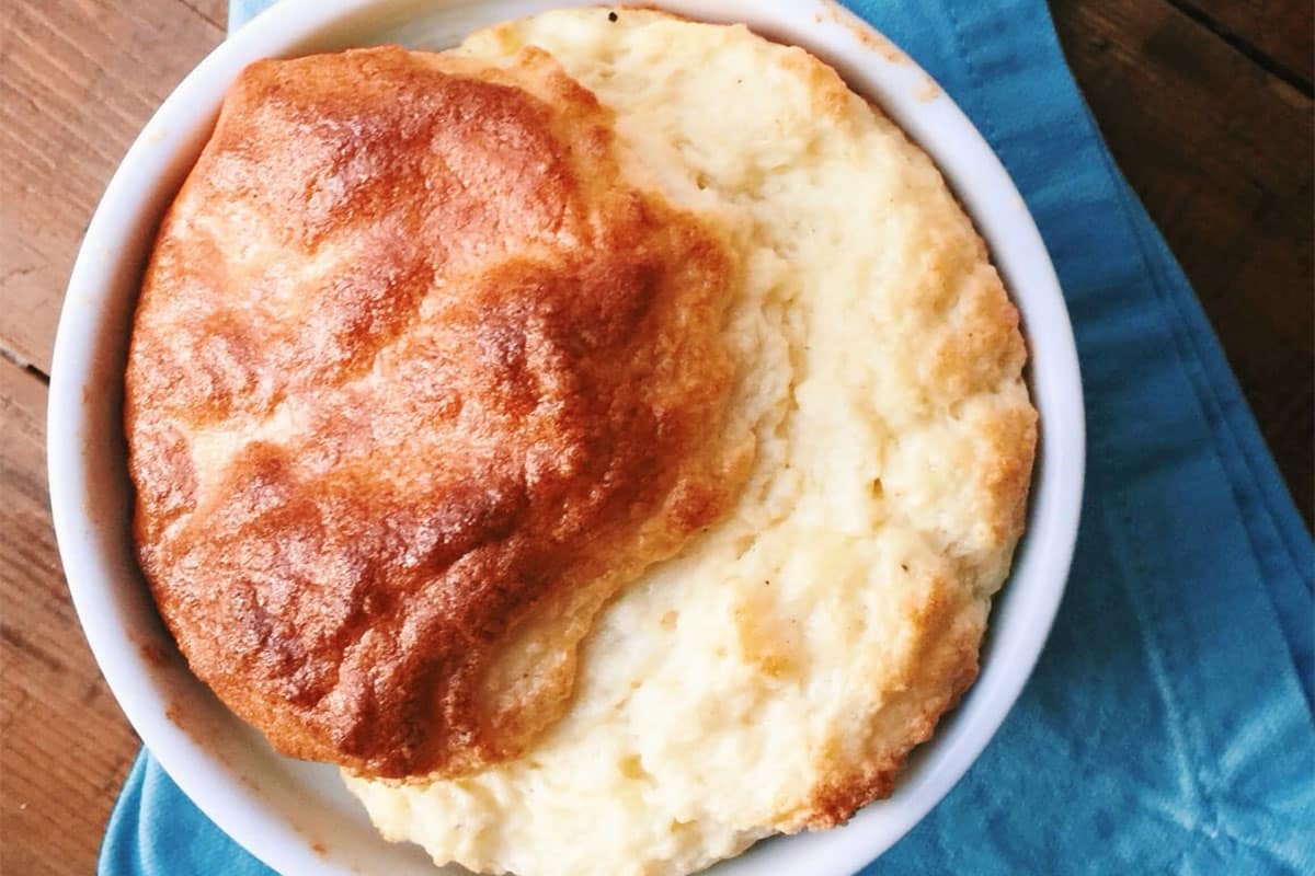 Cheese souffle in bowl on blue napkin.