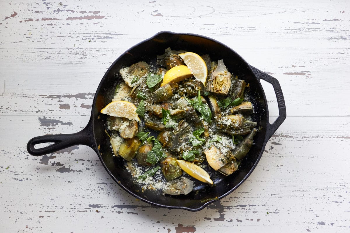 Skillet of Braised Baby Artichokes with Leeks and Capers.