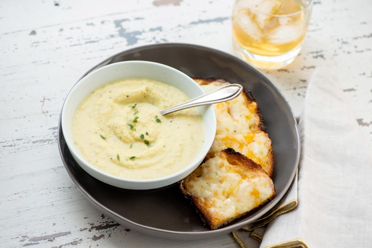 Plate with cheese toasts and a bowl of Parsnip and Golden Beet Soup.