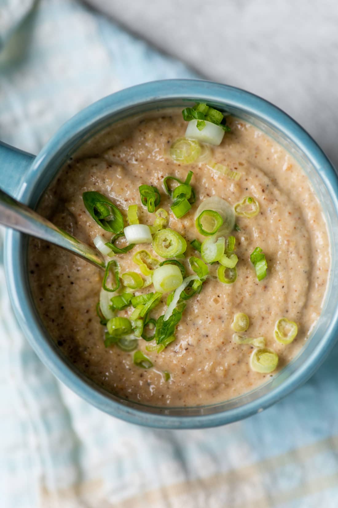 Roasted Cauliflower and Sunchoke Soup topped with sliced scallions.