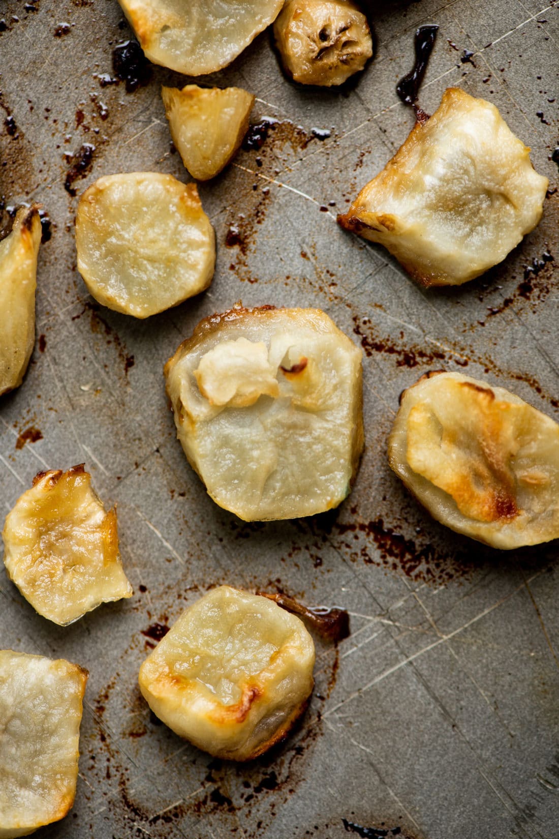 Roasted Jerusalem Artichokes on a baking sheet.