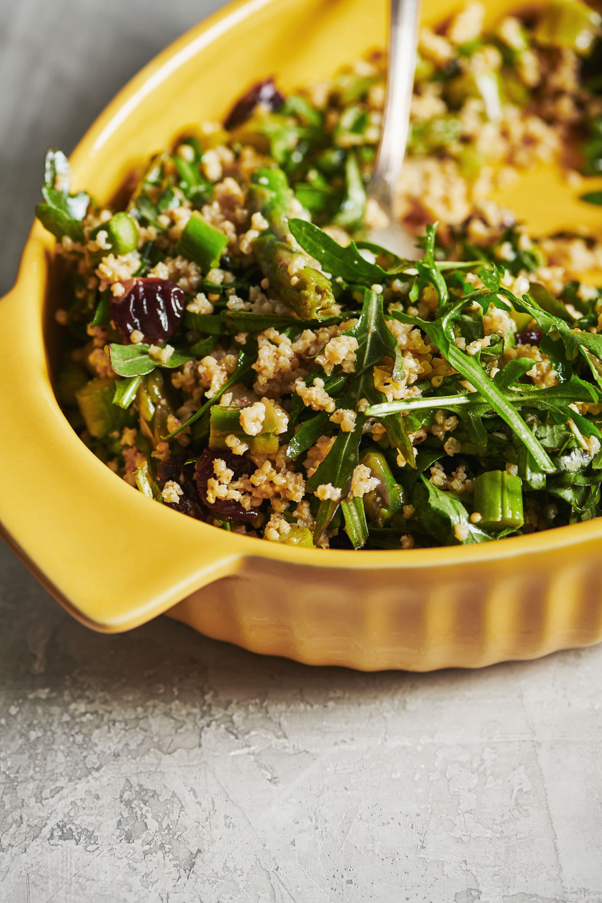 Yellow bowl of Millet and Greens Salad.