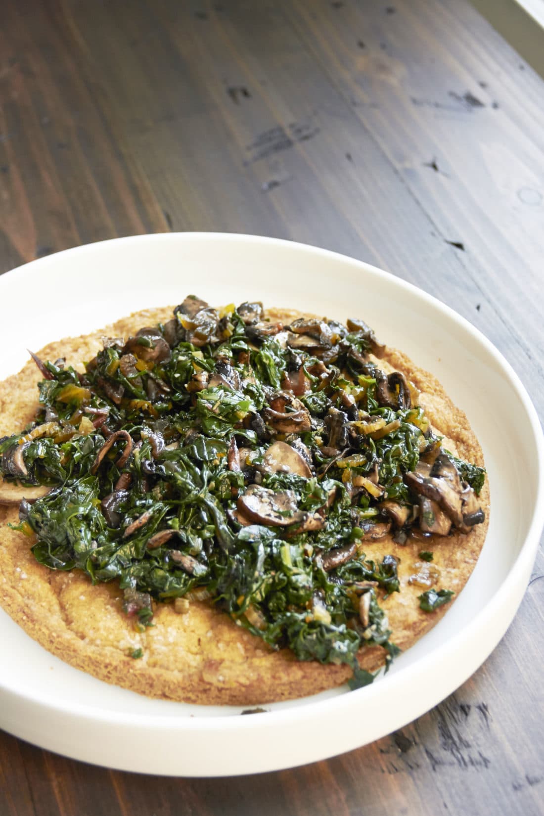 Big Biscuit with Swiss Chard and Mushrooms on a white plate.