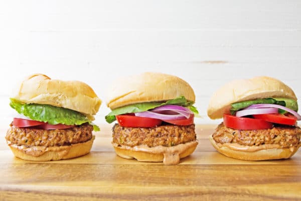 Line of Chipotle Barbecue Turkey Burgers on a wooden surface.
