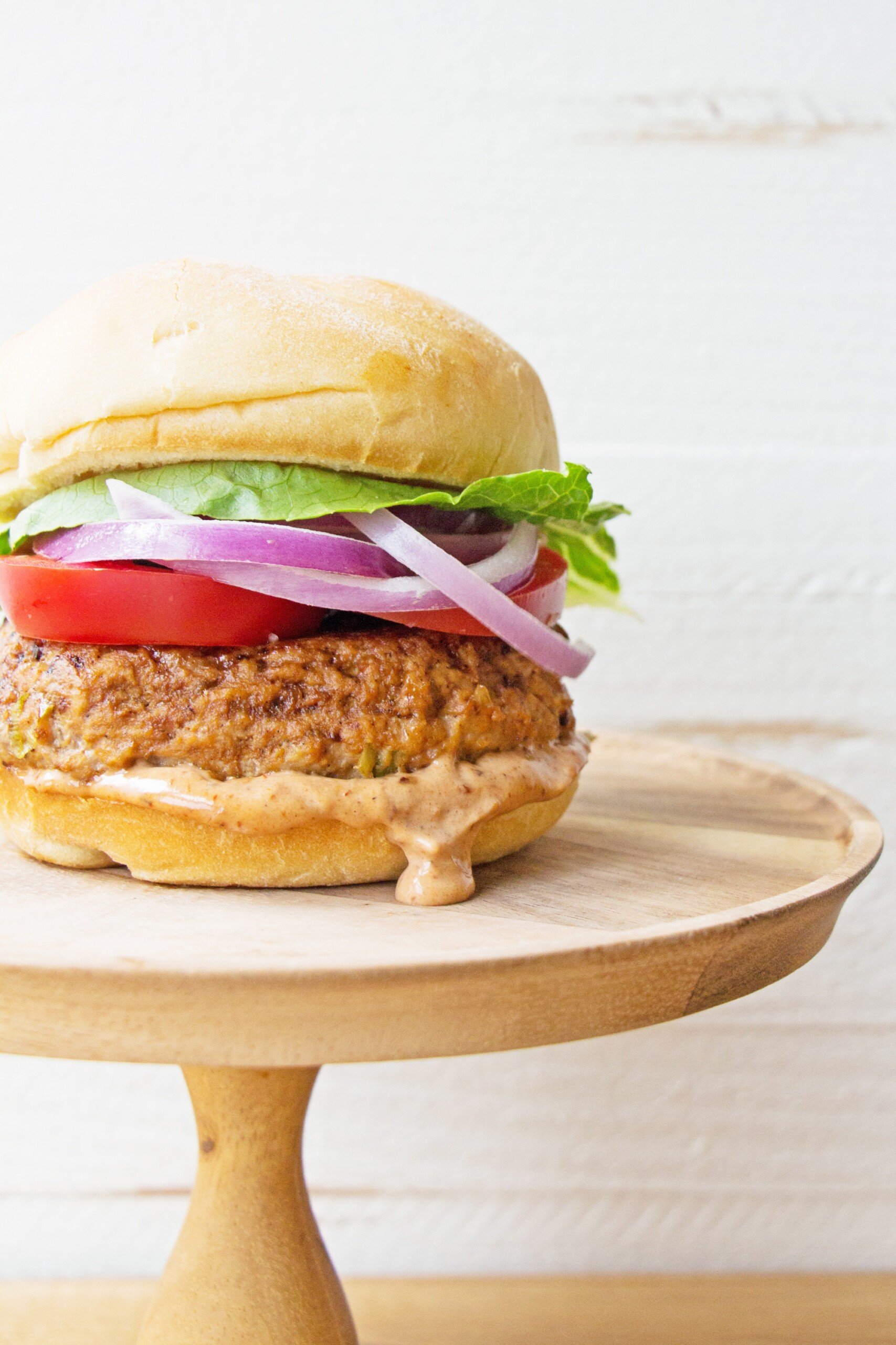 Chipotle Barbecue Turkey Burger on a wooden serving platform.