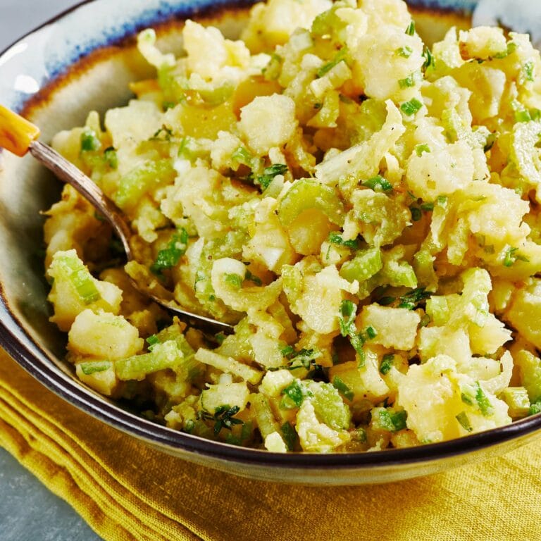 Bowl of Vegan Potato Salad with a spoon.