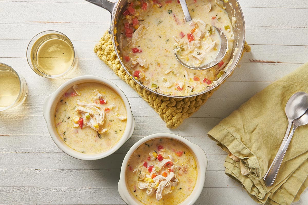 Chicken Corn Chowder in pot and bowls on table.