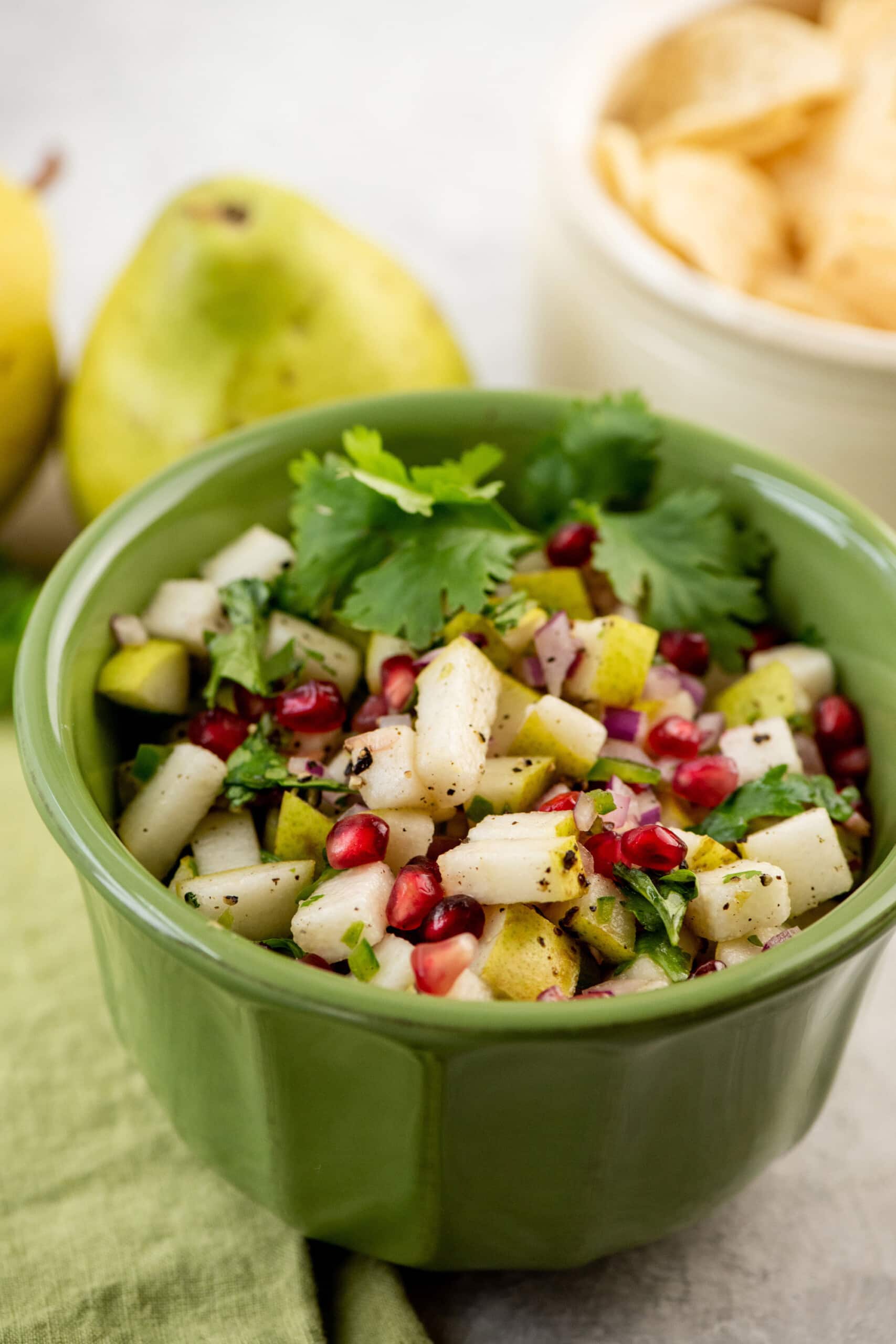Green bowl of Spicy Pear and Cilantro Salsa.