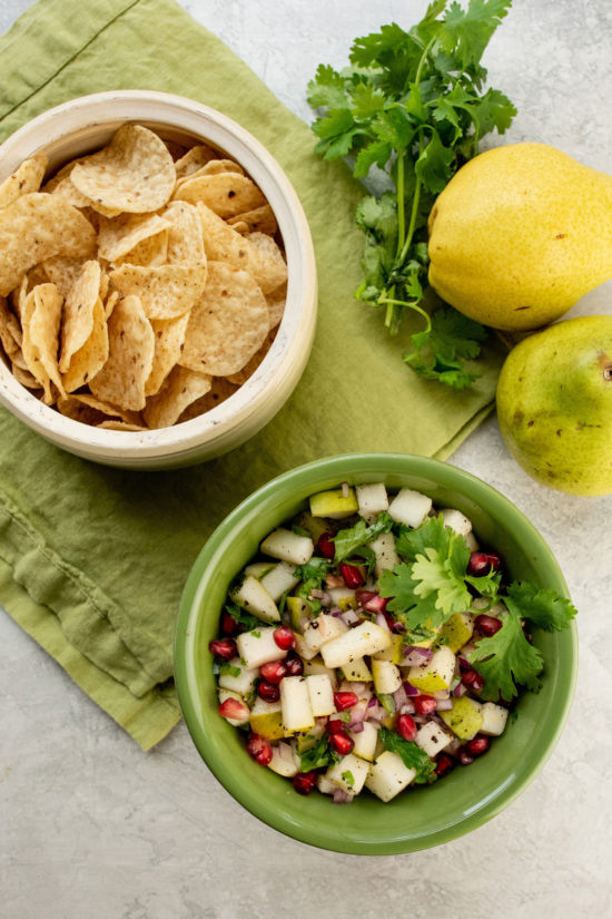 Bowls of tortilla chips and Spicy Pear and Cilantro Salsa.