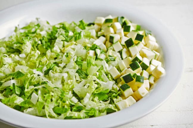 Large plate of lettuce and zucchini.