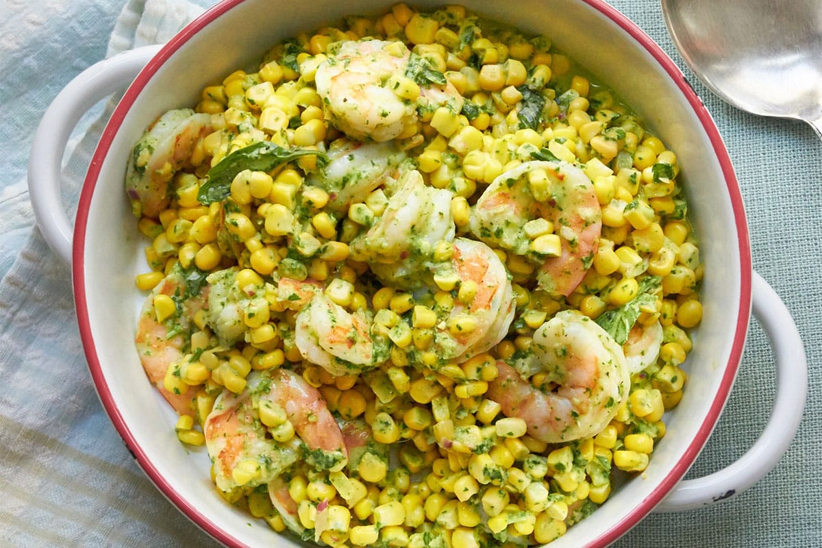 Handled bowl of Shrimp and Corn Salad with Basil Dressing.