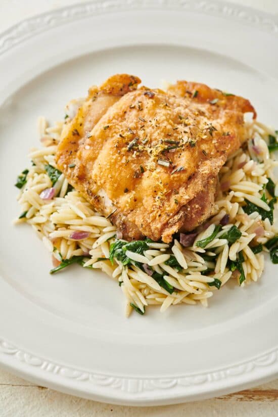Lemon Rosemary Chicken on a bed of orzo.
