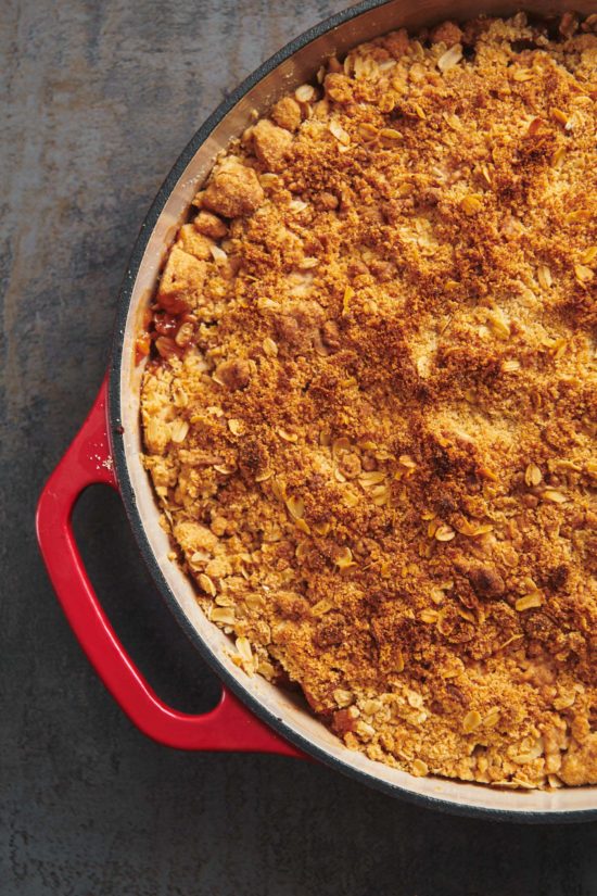 Apple crisp with streusel topping in red baking dish