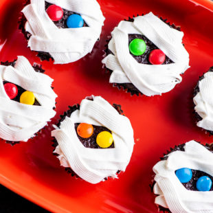 Mummy Cupcakes on a red platter.