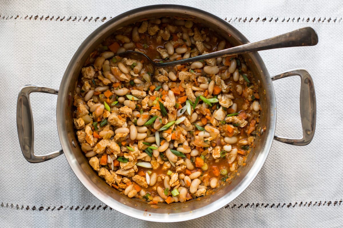 Spoon in a pot of Buffalo Chicken and White Bean Chili.