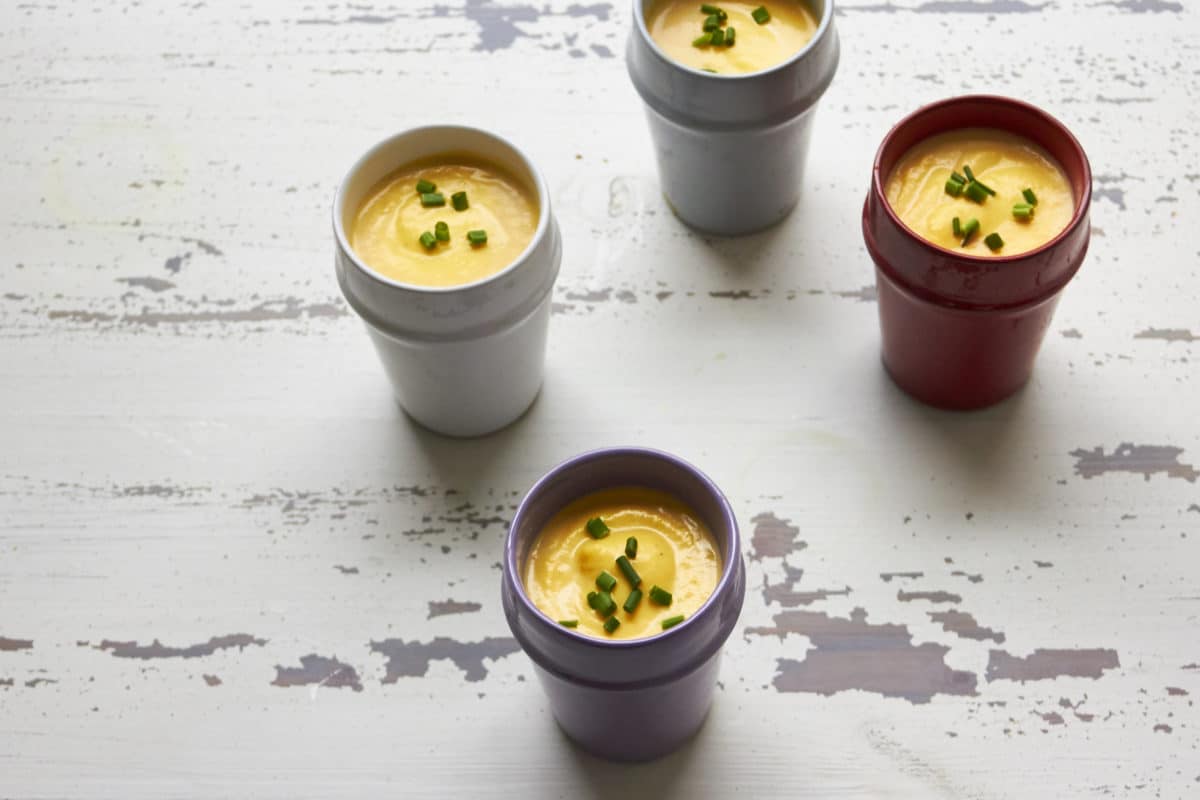 Small, differently colored cups of Butternut Squash and Fennel Soup.