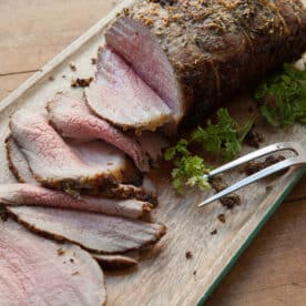 Roast Beef with Thyme and Rosemary on cutting board.