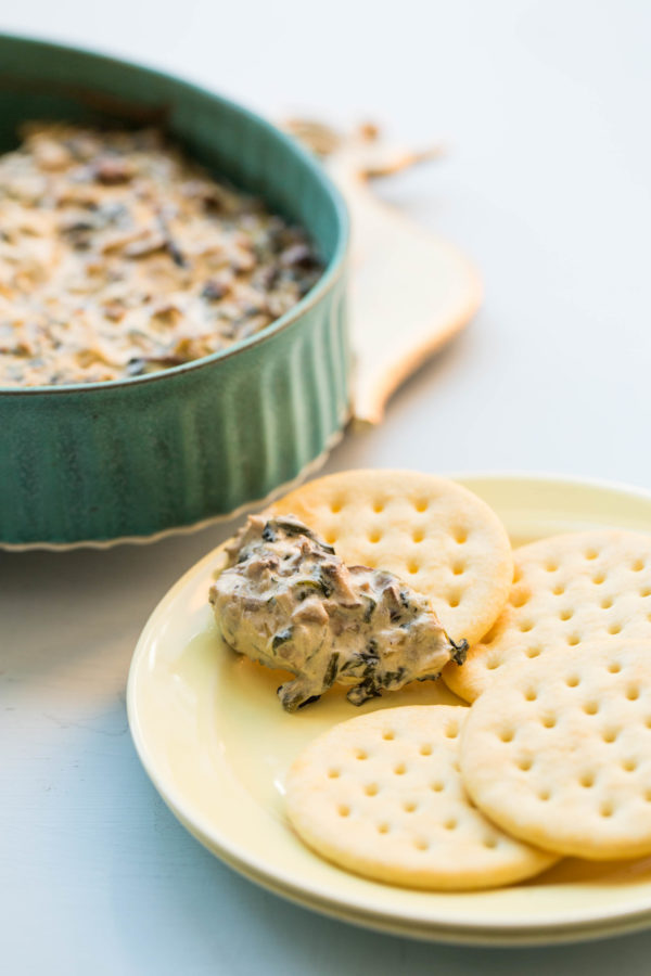 Hot Creamy Mushroom and Spinach Dip on a cracker.