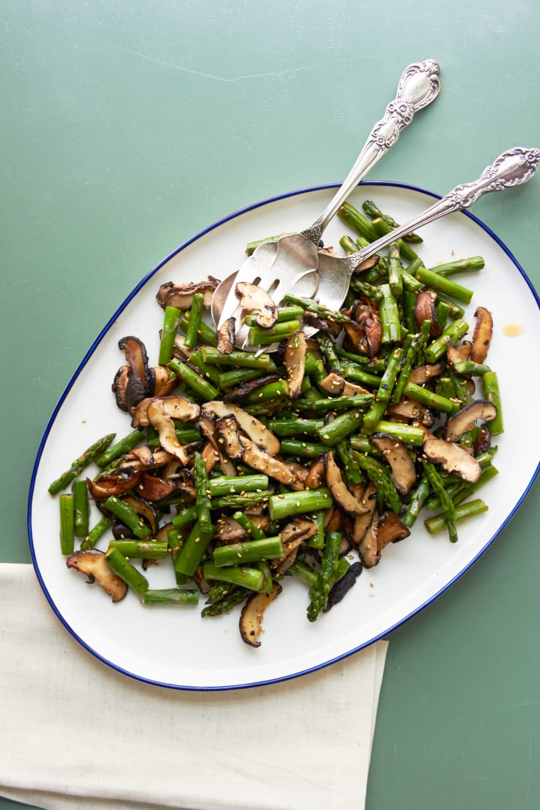 Sesame Asparagus and Shiitake Mushrooms on an oblong serving dish.