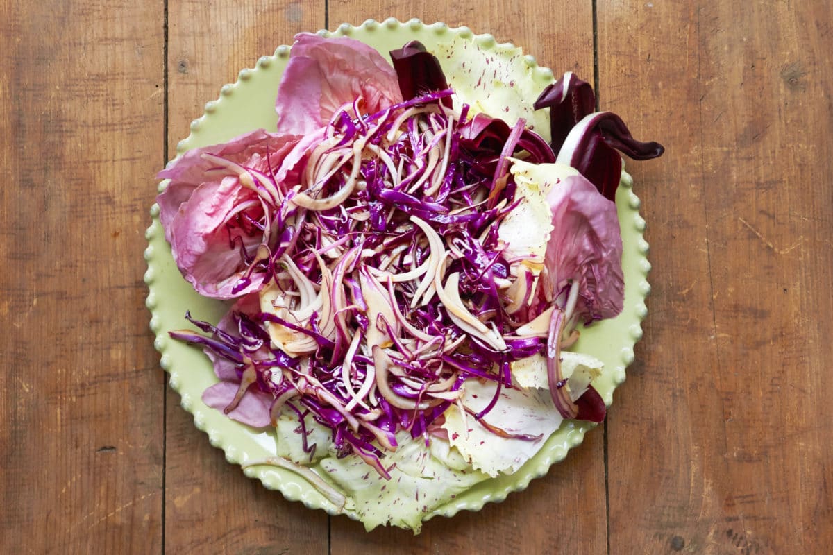 Red Salad with Radicchio, Citrus, Honey and Thyme Vinaigrette on a plate.
