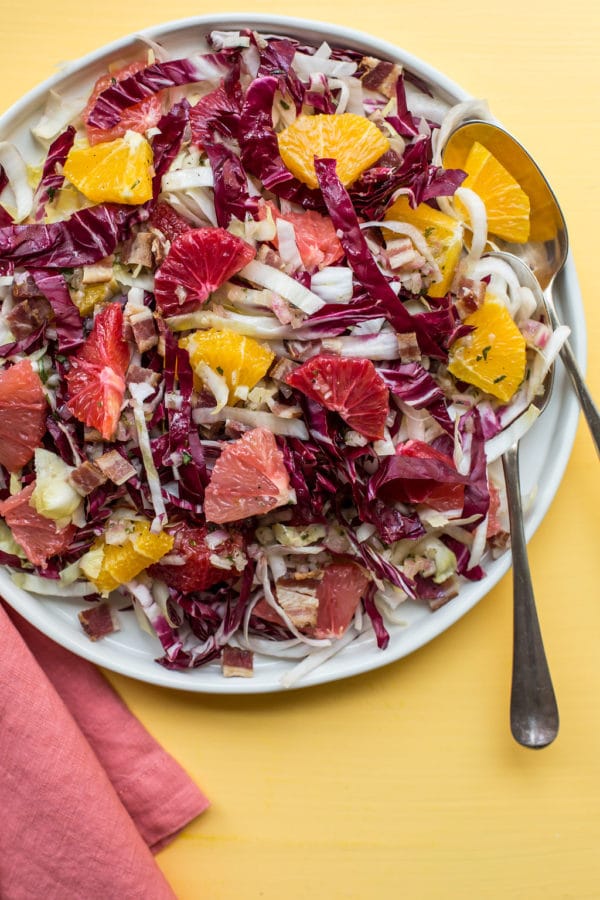 Endive, Radicchio and Citrus Salad with Bacon Vinaigrette on white plate.