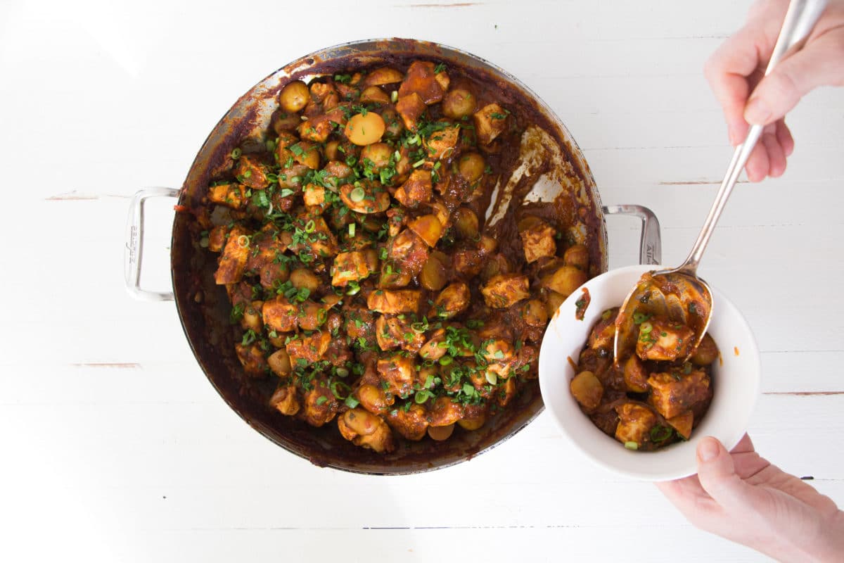 Indian Spiced Chicken and Potato Stew in a pot and in a bowl.