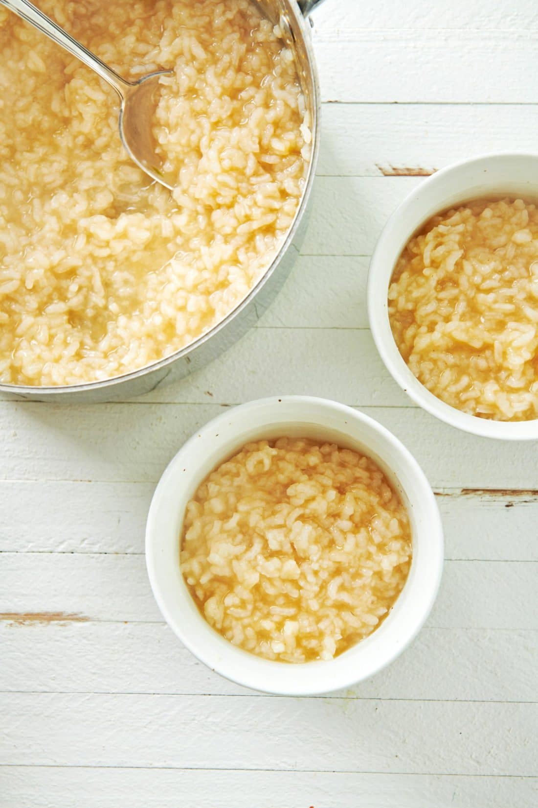 Two bowls and a pot of Congee (Chinese Rice Porridge).