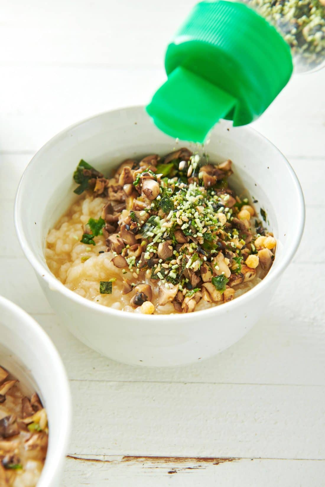 Sesame seeds pouring onto Congee (Chinese Rice Porridge).