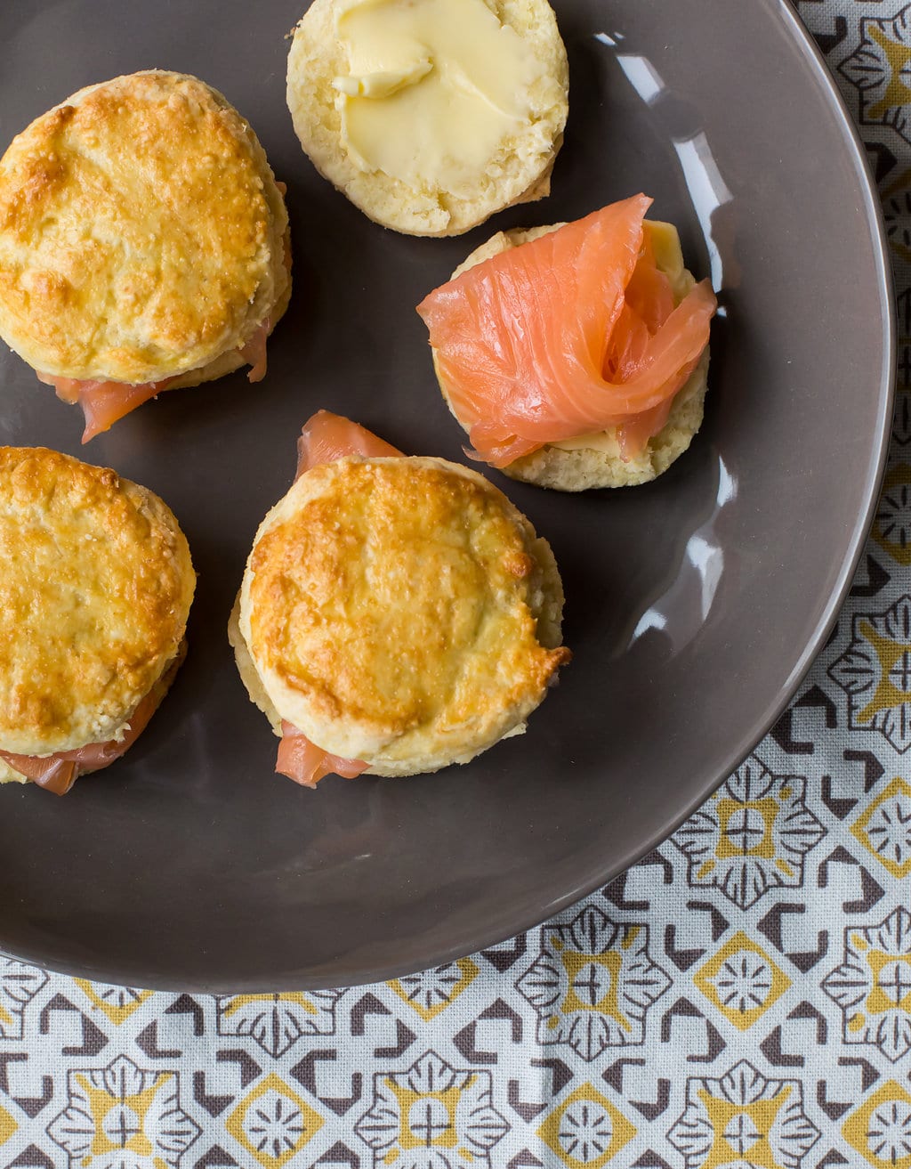 Grey plate with Irish scones topped with thin pieces of salmon.