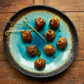 Plate of Japanese meatballs with glossy, sticky ponzu and soy sauce glaze.