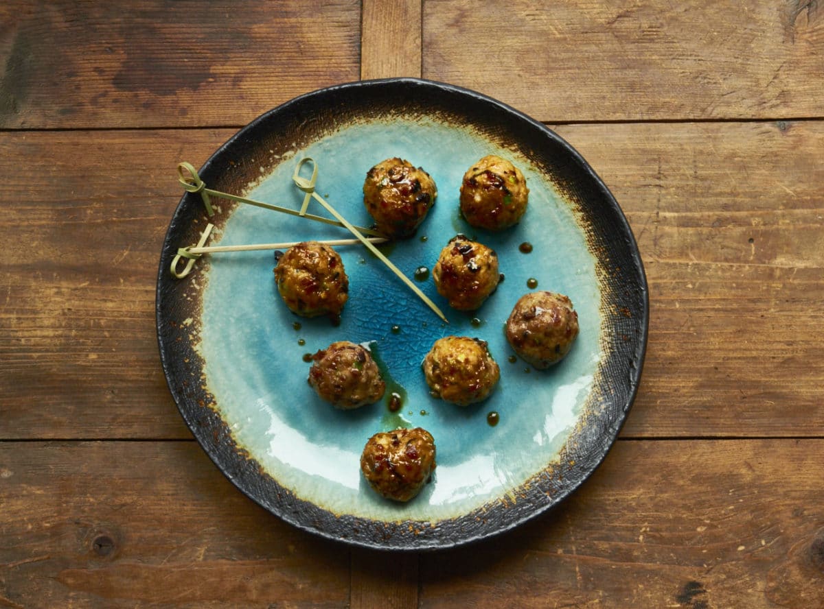 Plate of Japanese meatballs with Ponzu glaze.