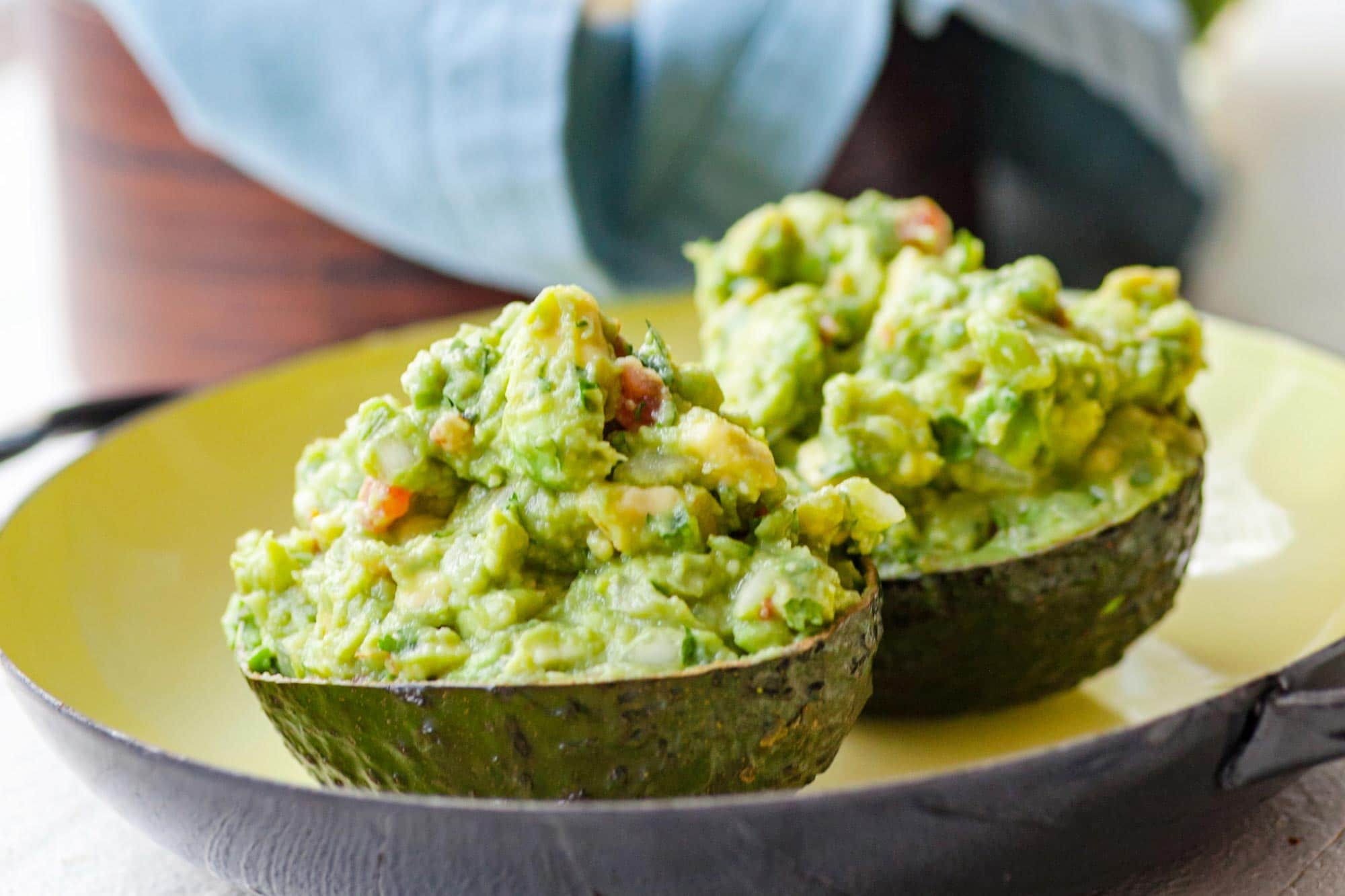 Avocado halves filled with Guacamole.