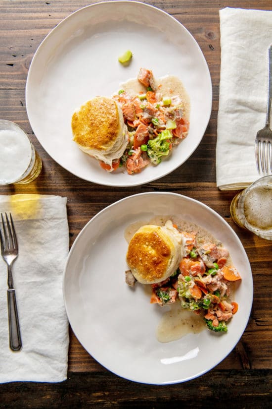 Two plates of Salmon and Vegetable Biscuit Pot Pie Casserole on a table