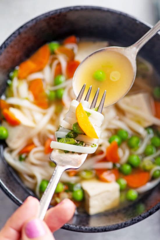 Fork and spoon of Vegetable Udon Noodle Soup.
