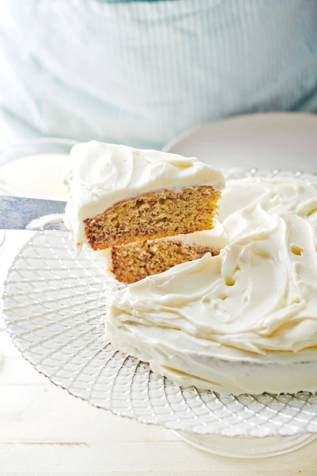 Spatula grabbing a slice of Banana Cake with Cream Cheese Frosting.